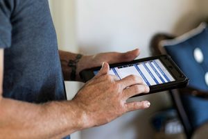 certified home inspector entering inspection details into reporting program on an iPad