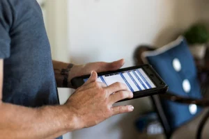 certified home inspector entering inspection details into reporting program on an iPad